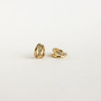 Two small gold Amelia Duo Huggies featuring embedded clear stones and pave accents, shown on a plain white background.