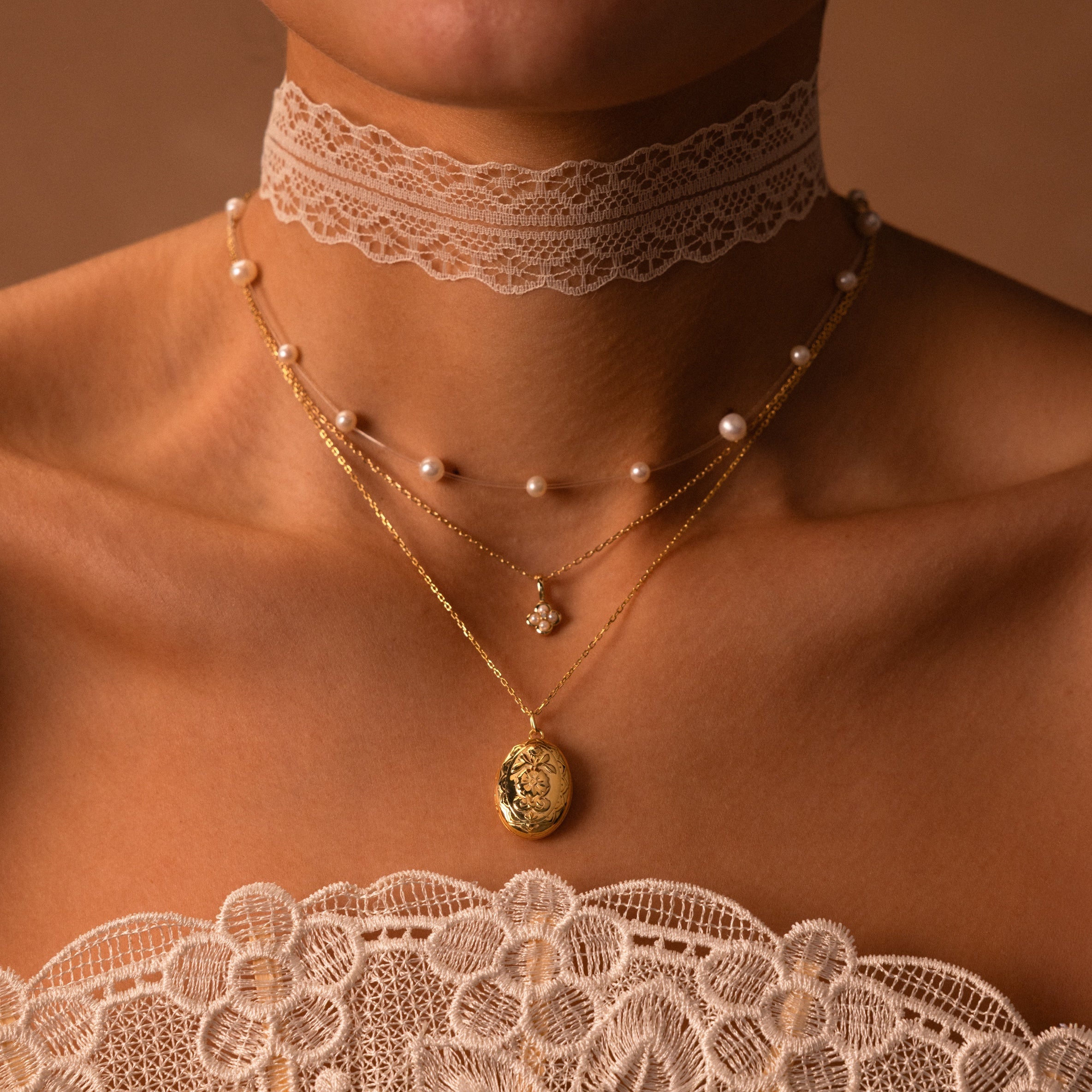 Woman wearing a lace choker, Rounded Pearl Flower Necklace, and two gold chain pendant necklaces with a lace top—a perfect showcase of delicate floral jewelry.