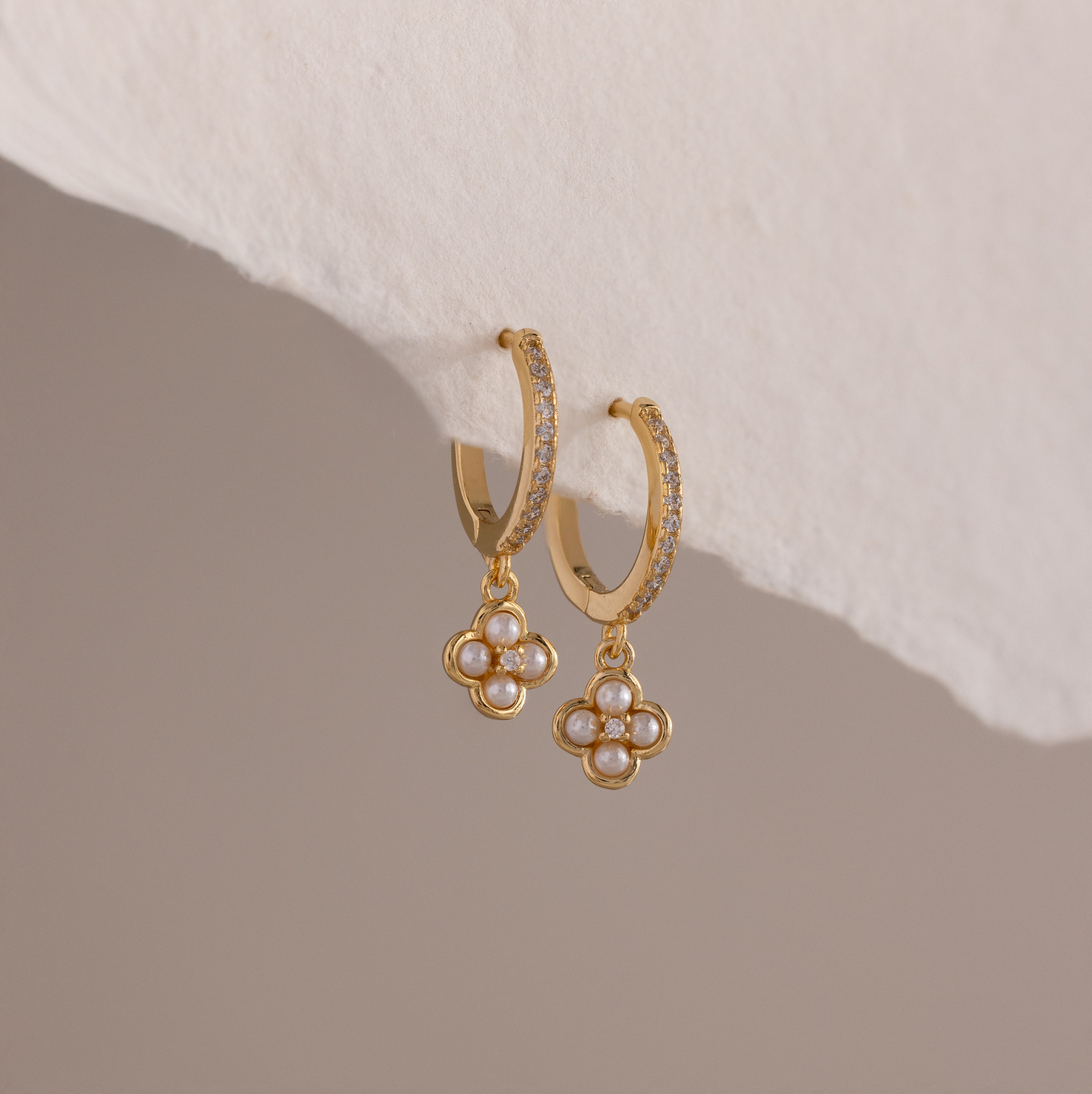 Pave Rounded Pearl Flower Hoops in 18K Gold, featuring pearl-studded floral pendants, are displayed on a soft, neutral background—perfect as elegant wedding earrings.