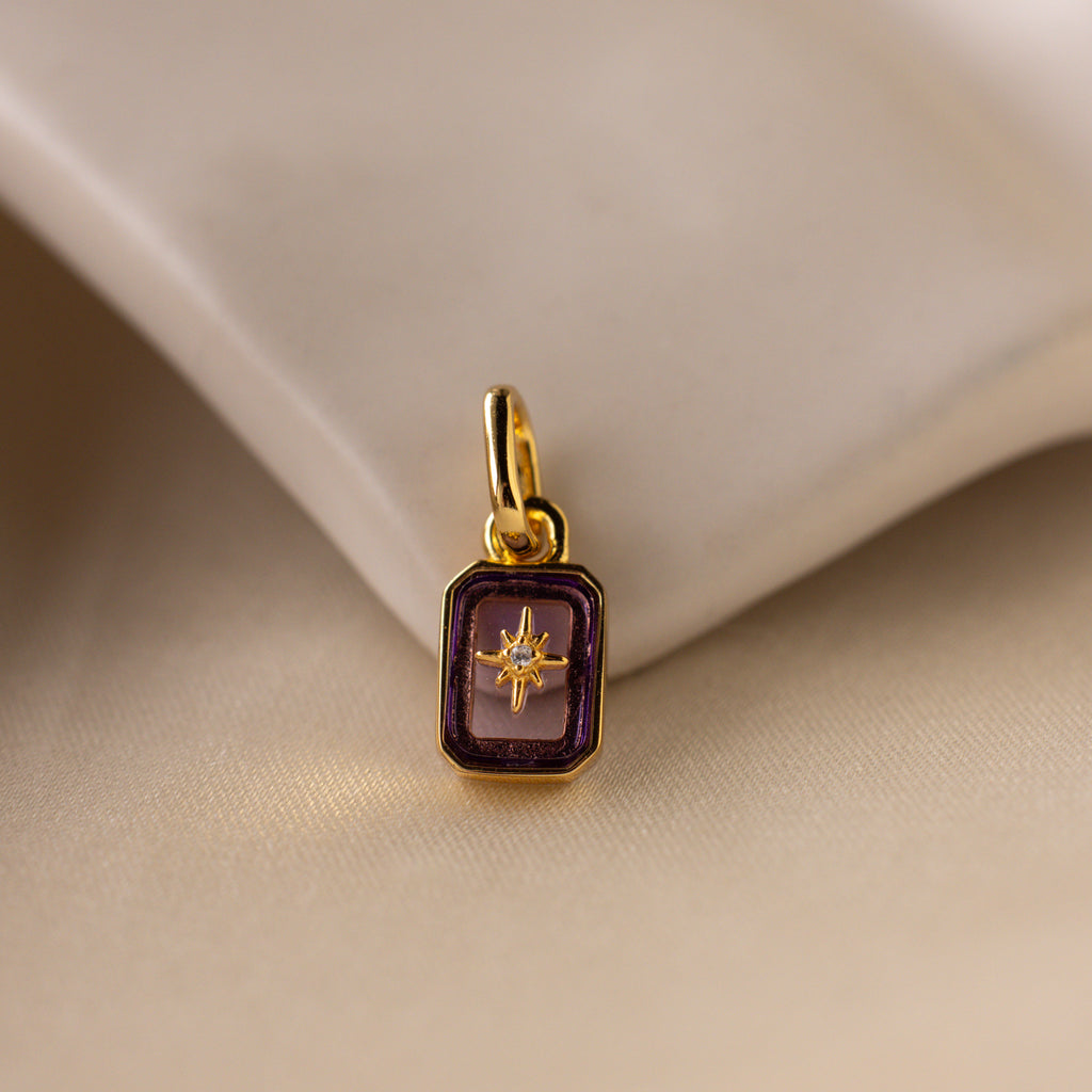 Up close of a purple amethyst north star charm with a pavé CZ diamond in the center.