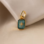 Up close of a turquoise blue zircon north star charm with a delicate pavé diamond in the center.