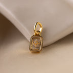 Up close of a clear diamond north star charm with a delicate pavé diamond in the center.