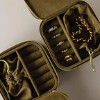 Two Green Velvet Jewelry Boxes, perfect for travel, open to display assorted gold and silver rings and bracelets.