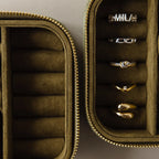 The Green Velvet Jewelry Box offers elegant storage, keeping gold and silver rings neatly organized in separate compartments.