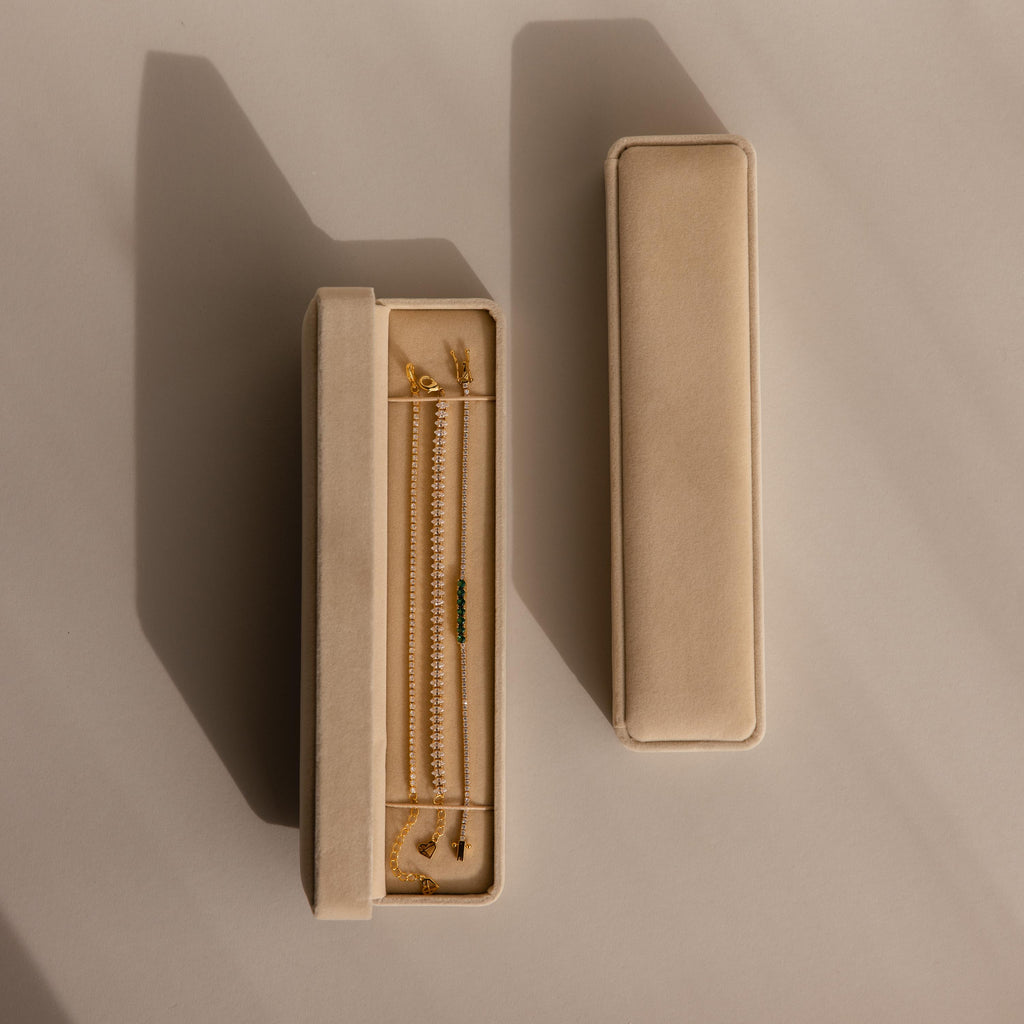 Two beige velvet Bracelet Travel Cases, one open with displayed gold jewelry, rest on a neutral background with soft shadows—perfect as a bracelet organizer or elegant travel case.