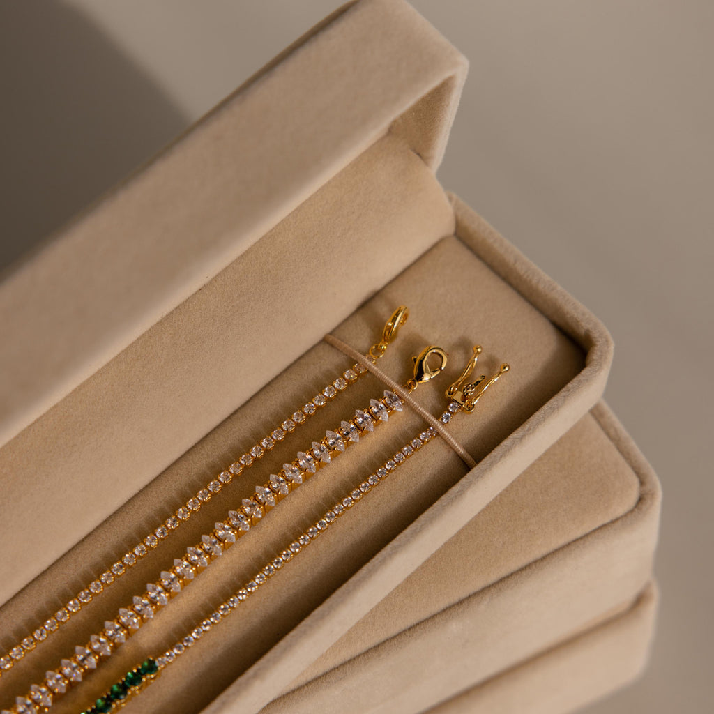 Gold and diamond tennis bracelets beautifully arranged in the Bracelet Travel Case, a chic beige velvet organizer.