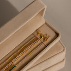 Gold and diamond tennis bracelets beautifully arranged in the Bracelet Travel Case, a chic beige velvet organizer.