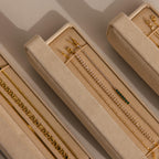 Gold and diamond bracelets and earrings organized in a velvet Bracelet Travel Case, showcased under soft lighting.