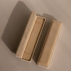 Two beige velvet Bracelet Travel Cases—one open, one closed—rest on a neutral background, perfect for organizing or traveling with your bracelets.