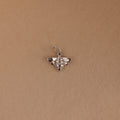 The Honeybee Charm in Sterling Silver, ideal for nature jewelry lovers, is shown on a simple light brown background.