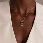 The Honeybee Charm in 18K Gold pendant necklace, styled with a cream-colored blazer, makes a stunning piece of nature-inspired jewelry.