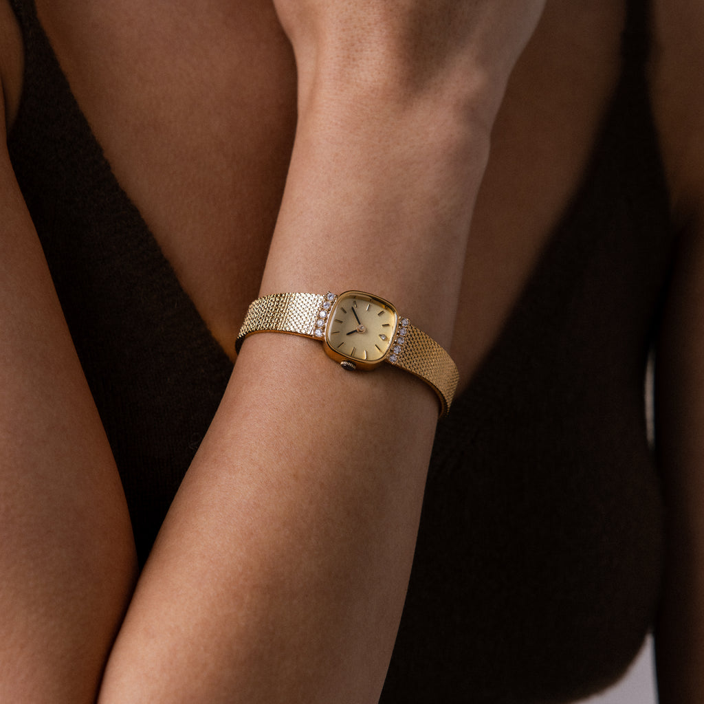 Close up of our Luxe Square Timepiece in 18K Gold watch on a wrist