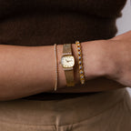 Close up of our Luxe Square Timepiece watch in 18K Gold, styled with our Classic Diamond Tennis Bracelet and Heart Diamond Bracelet.