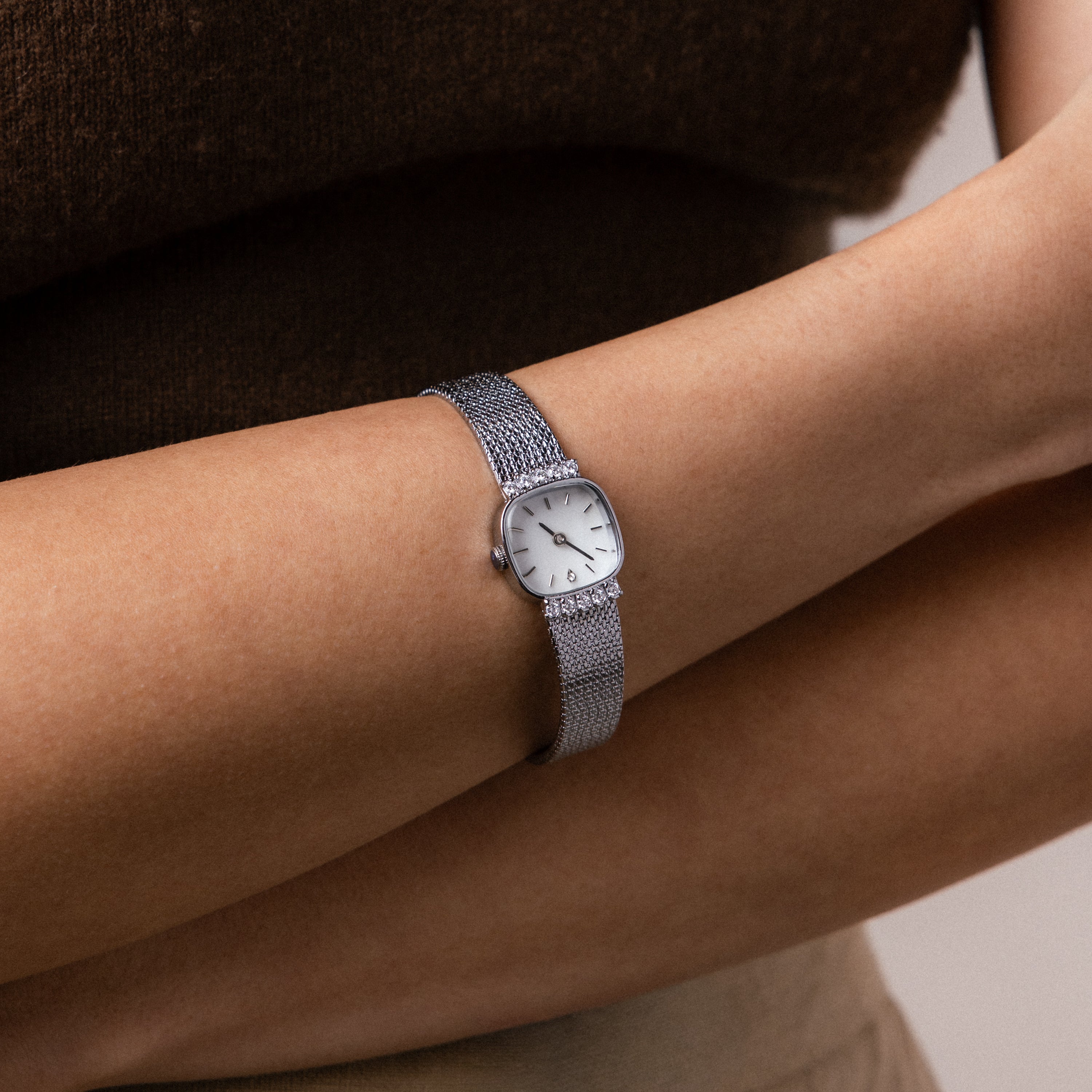 Close up of our Luxe Square Timepiece watch in Sterling Silver on a wrist