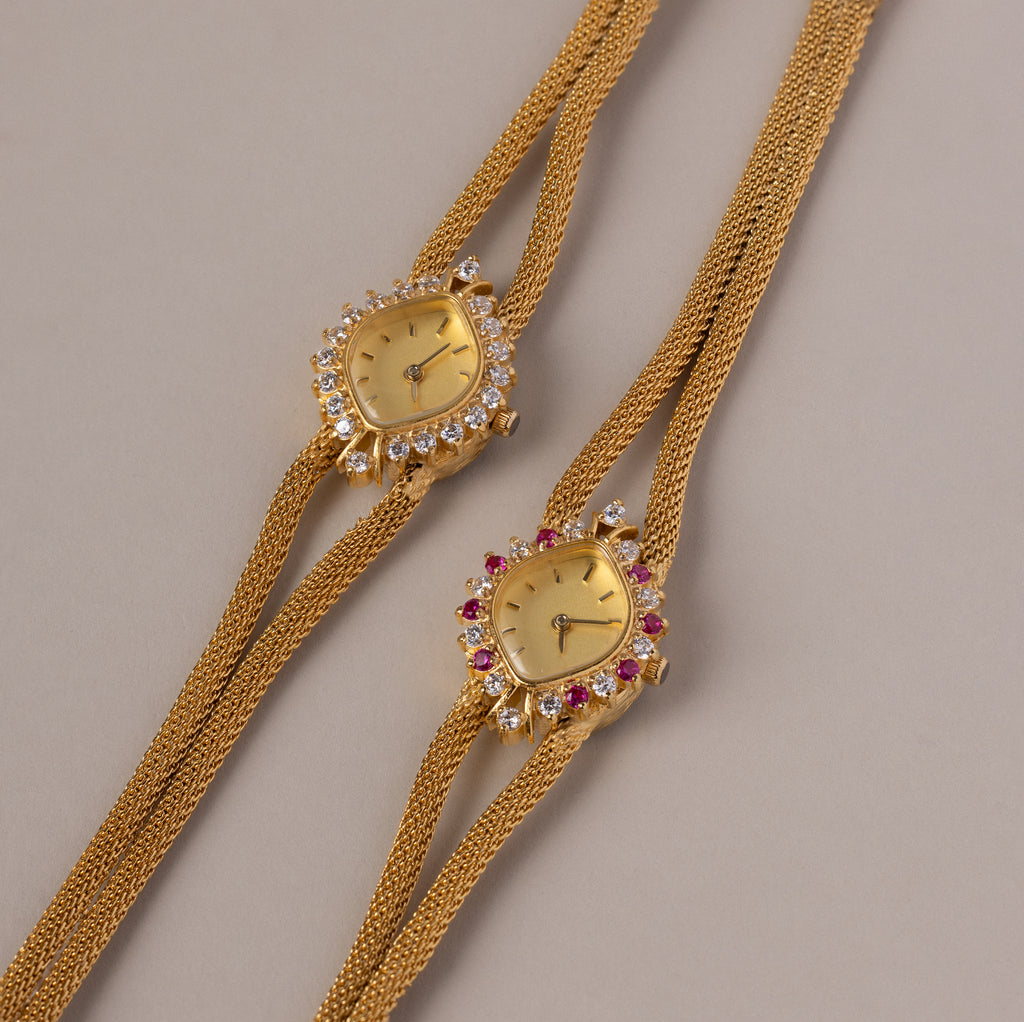 Close up flatlay image of both our Duo Chain Gemstone Timepiece watch in Diamond and Ruby