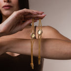 Women holding our Duo Chain Gemstone Timepiece watch, showcasing both diamond and ruby versions