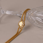 Close up of our Duo Chain Diamond Timepiece watch against a clear glass cup