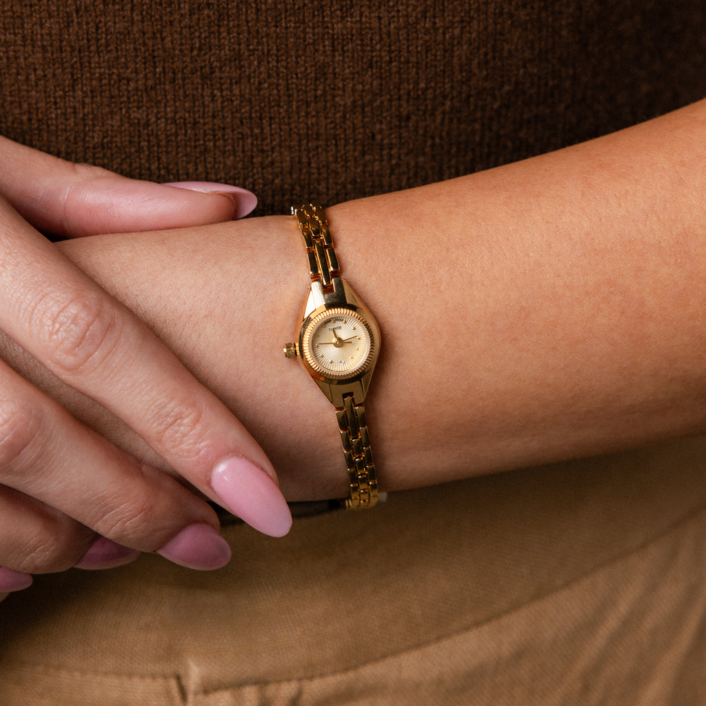 Close up of a wrist wearing our Petite Round Timepiece watch 