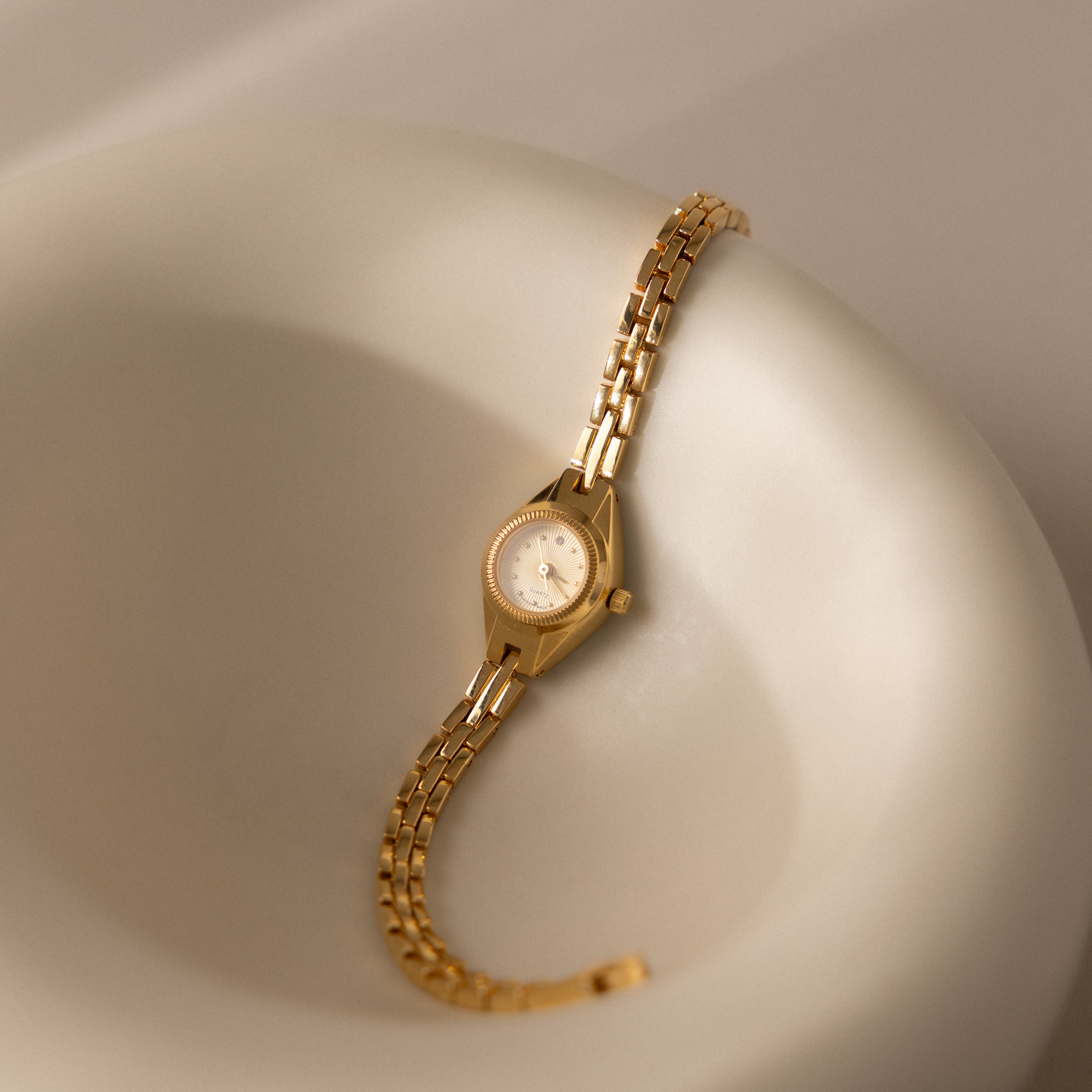 Our Petite Round Timepiece watch in a ceramic display dish