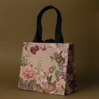The Gift Wrap Add-On features a floral-patterned handbag with dark handles on an olive-green background, making it perfect for elegant gift wrapping or adding a special touch to any thoughtful present.