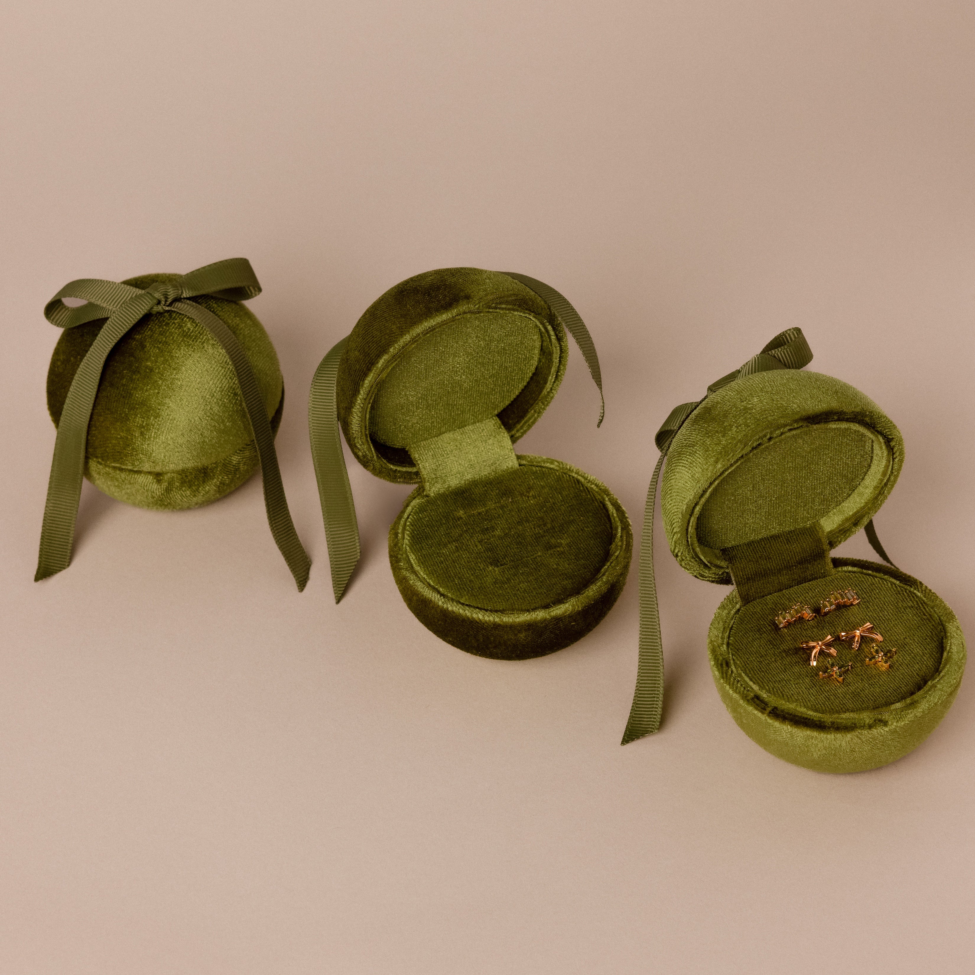 Three Velvet Round Ring Boxes in green velvet—two open, one closed—with one showing gold branch-shaped earrings. The perfect jewelry gift box for your treasures.