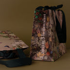 The Gift Wrap Add-On features floral gift bags with black ribbon handles on a brown surface—an elegant choice that adds a special finishing touch to any present.