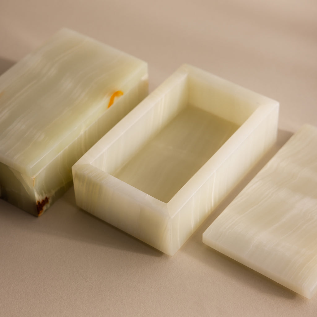 Green Onyx Jewelry Box with lid removed, showcasing its smooth, creamy light green marble texture on a beige surface.