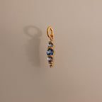 Ombre Lace Aquamarine Charm pendant featuring four blue gemstones in a vertical line on a light beige background—an elegant personalized birth month gift.