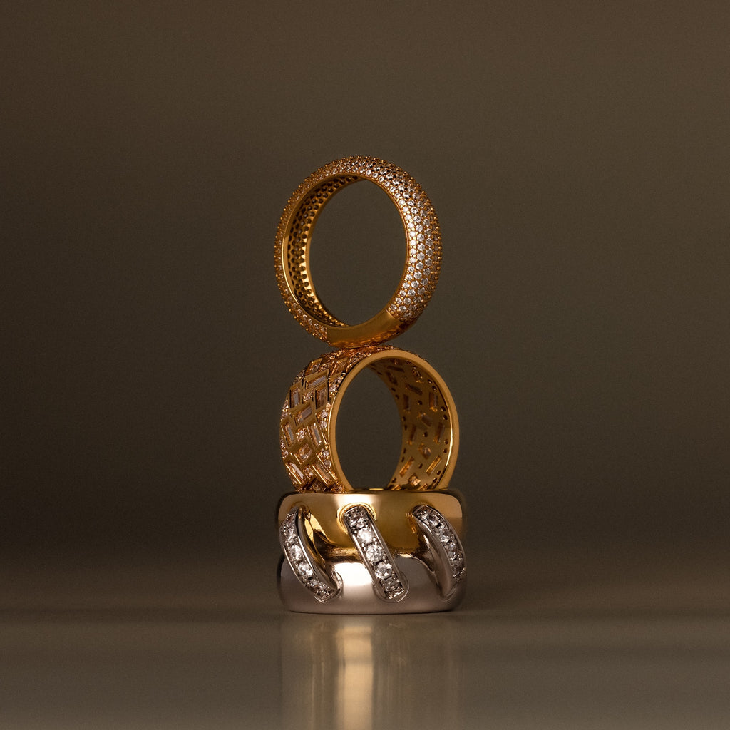 The Bold Pave Stacking Ring features elegant gold and silver tones with diamond accents, stacked vertically—perfect as an anniversary ring or wedding band.
