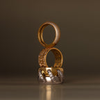 The Bold Pave Stacking Ring features elegant gold and silver tones with diamond accents, stacked vertically—perfect as an anniversary ring or wedding band.