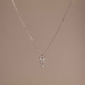 Butterfly Drop Necklace in Sterling Silver features a delicate butterfly pendant, ideal for nature-inspired jewelry lovers, and is shown on a plain beige background.