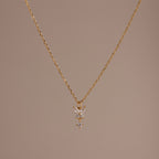 Butterfly Drop Necklace in 18K Gold features a delicate butterfly pendant, shown on a plain beige background—a perfect piece for lovers of nature-inspired jewelry.