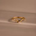 Gold curve marquise diamond ring with three sparkling marquise-cut diamonds in a chevron setting.