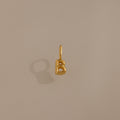 The Bubble Letter Charm in 18K Gold, shaped like a "B," is displayed on a beige background—ideal as personalized jewelry or a chic addition to your charm bracelet collection.