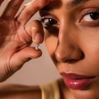 Close-up of a woman holding the Baguette Diamond Charm in Silver near her face, showcasing its detail and brilliance—perfect for highlighting this sparkling silver jewelry piece with diamond accents in SEO-driven product descriptions.
