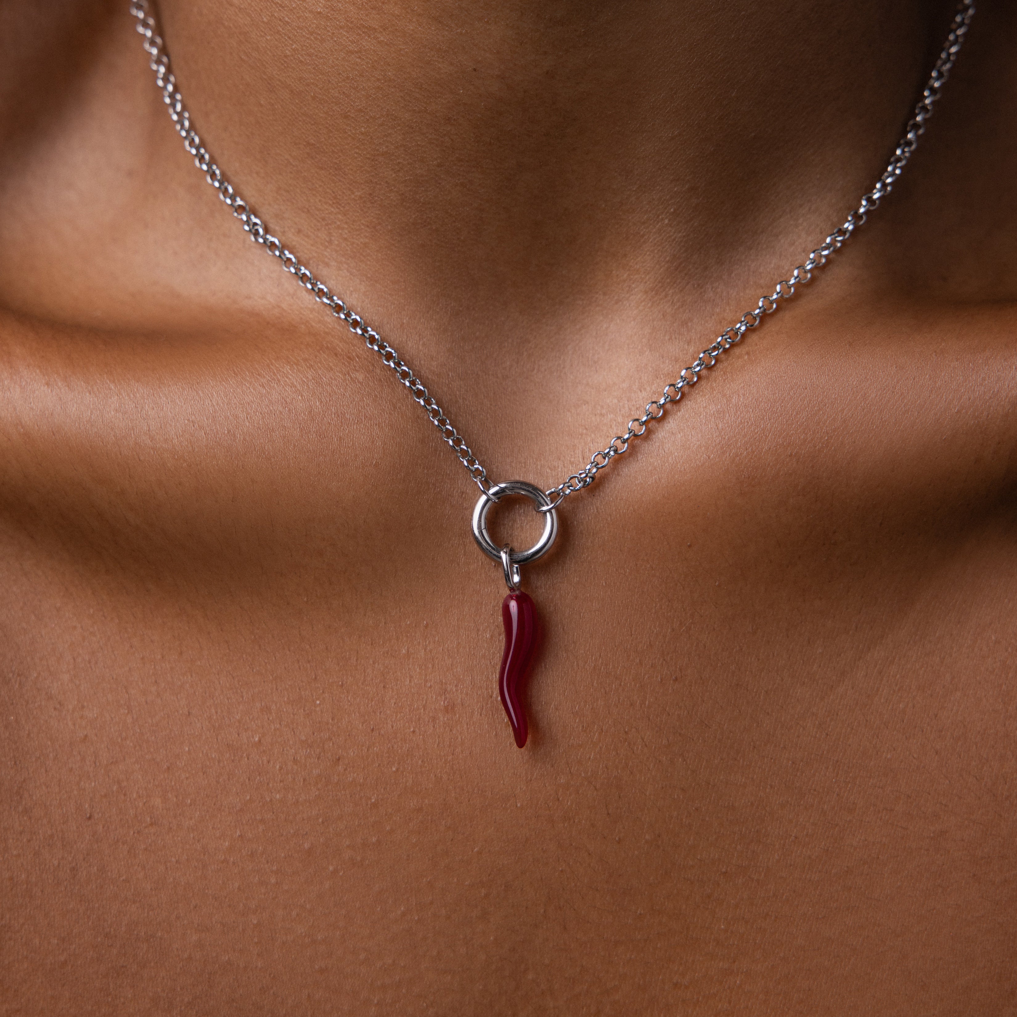The Chili Pepper Charm in Sterling Silver necklace adds a vibrant, playful accent to the neck and collarbone, enhancing any jewelry collection with its unique design.