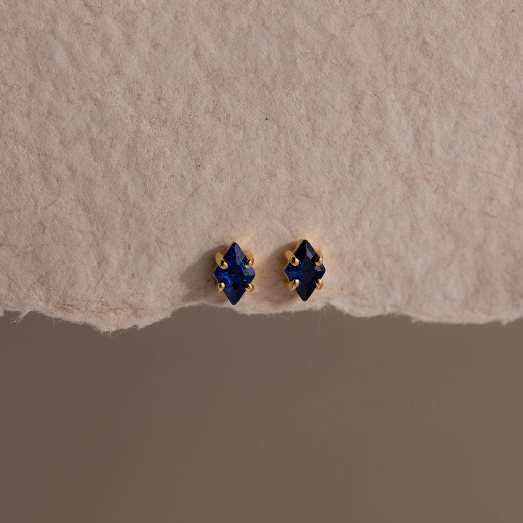 A pair of Rhombus Sapphire Flatback Studs, ideal for adding understated charm and modern glamour to any look.
