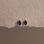 A pair of Rhombus Sapphire Flatback Studs, ideal for adding understated charm and modern glamour to any look.