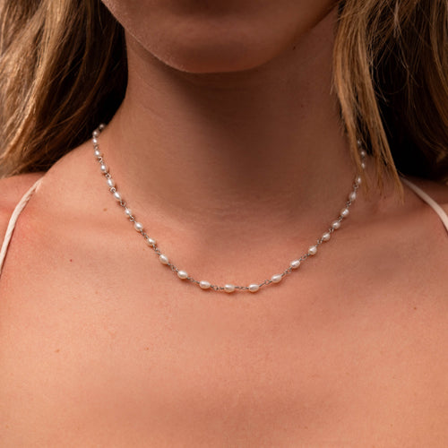 Aurora Pearl Station Necklace with small freshwater pearls on a delicate silver chain.