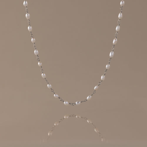 Aurora Pearl Station Necklace with luminous freshwater pearls on a delicate silver chain.