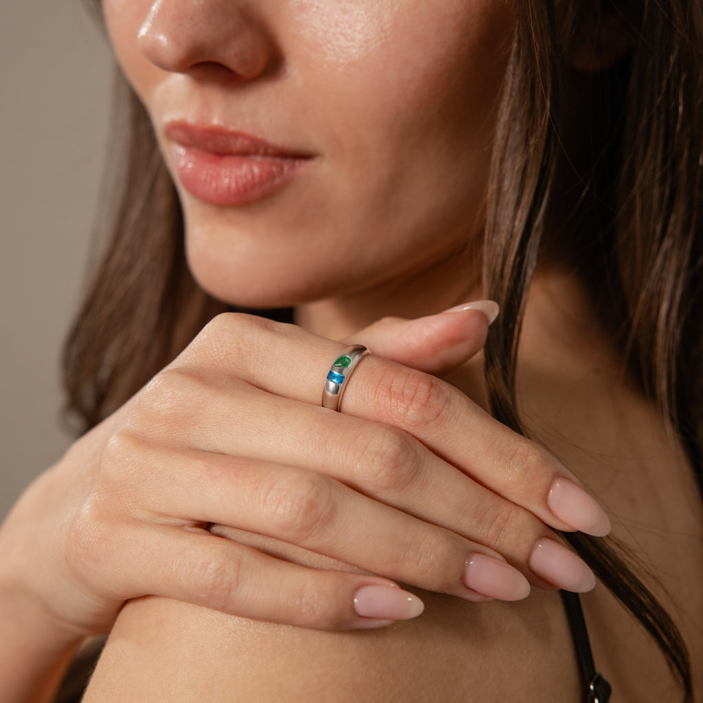 A woman with long brown hair and neatly manicured nails shows off the Toi et Moi Dome Ring in Silver on her finger.