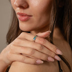 A woman with long brown hair and neatly manicured nails shows off the Toi et Moi Dome Ring in Silver on her finger.