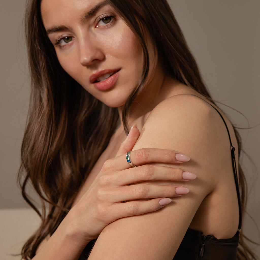 Woman with long brown hair in a black top shows off the Toi et Moi Dome Ring in Silver on her finger while looking at the camera.