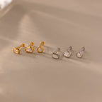 The Diamond Bezel Flatback Studs Set features six unique geometric-shaped stud earrings, in gold and silver tones—ideal for fans of classic studs or sleek, modern designs.