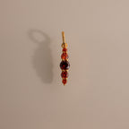 The Ombre Lace Garnet Charm is a gold pendant with red and purple gemstones set vertically—an elegant, personalized charm and perfect gift for a birth month.