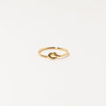 The Knot Ring in 18K Gold features a delicate knot design at the center, shown on a white background—ideal as a meaningful symbol or an elegant wedding gift.