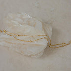 Delicate gold chain necklace with small beads draped over a light crystal—pair it with the Duo Bead Chain Anklet for a cohesive, boho-inspired style.