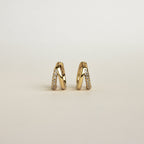 Product display of Amelia Duo Huggies in 18K Gold standing upright on a light background.