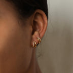 Side view of Amelia Duo Huggies stacked on a model’s ear, showing their dual-band design.