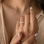 A hand with white nail polish wears the Colette Eternity Ring in Silver on the ring finger.